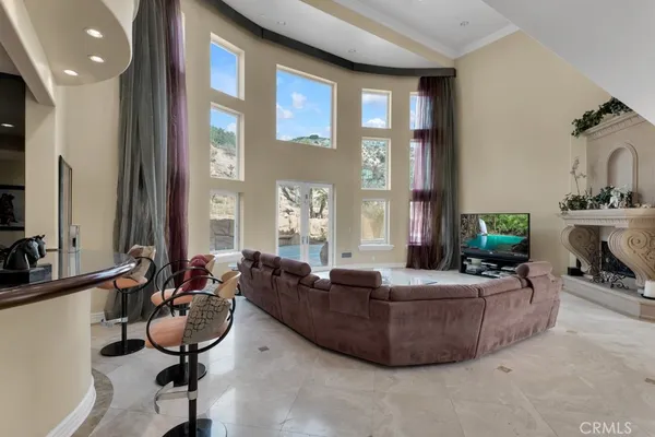 a living room with furniture and a chandelier