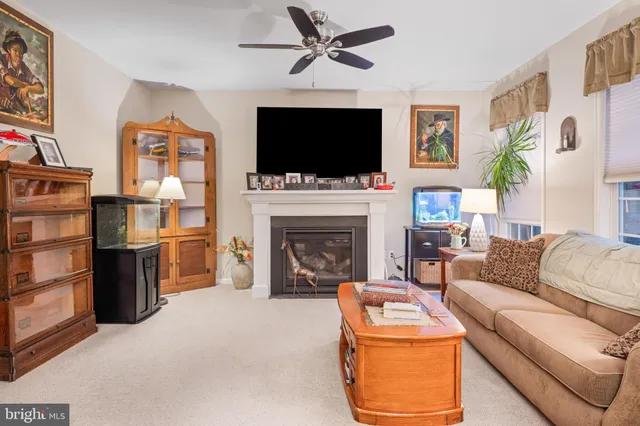 a living room with furniture fireplace and a flat screen tv