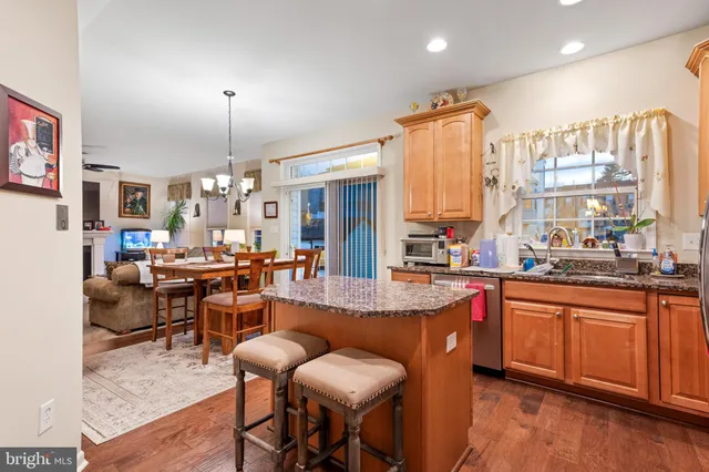 a large kitchen with a large counter top furniture appliances and wooden floor