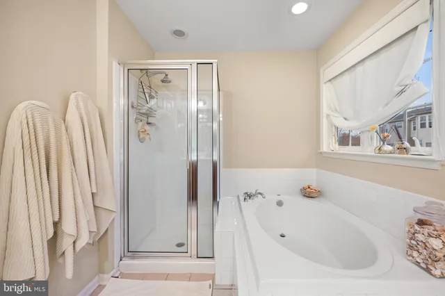 a bathroom with a tub and a window