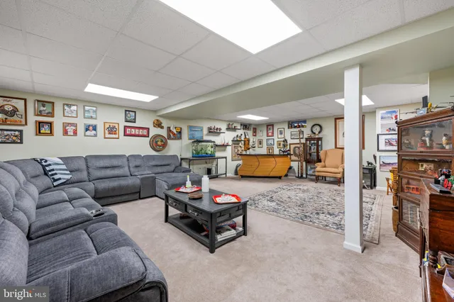 a living room with furniture a flat screen tv and a table
