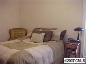 288 Patternote Road Mooresville, NC 28117 - Photo 6 of 8 a large bed sitting in a bedroom next to a lamp