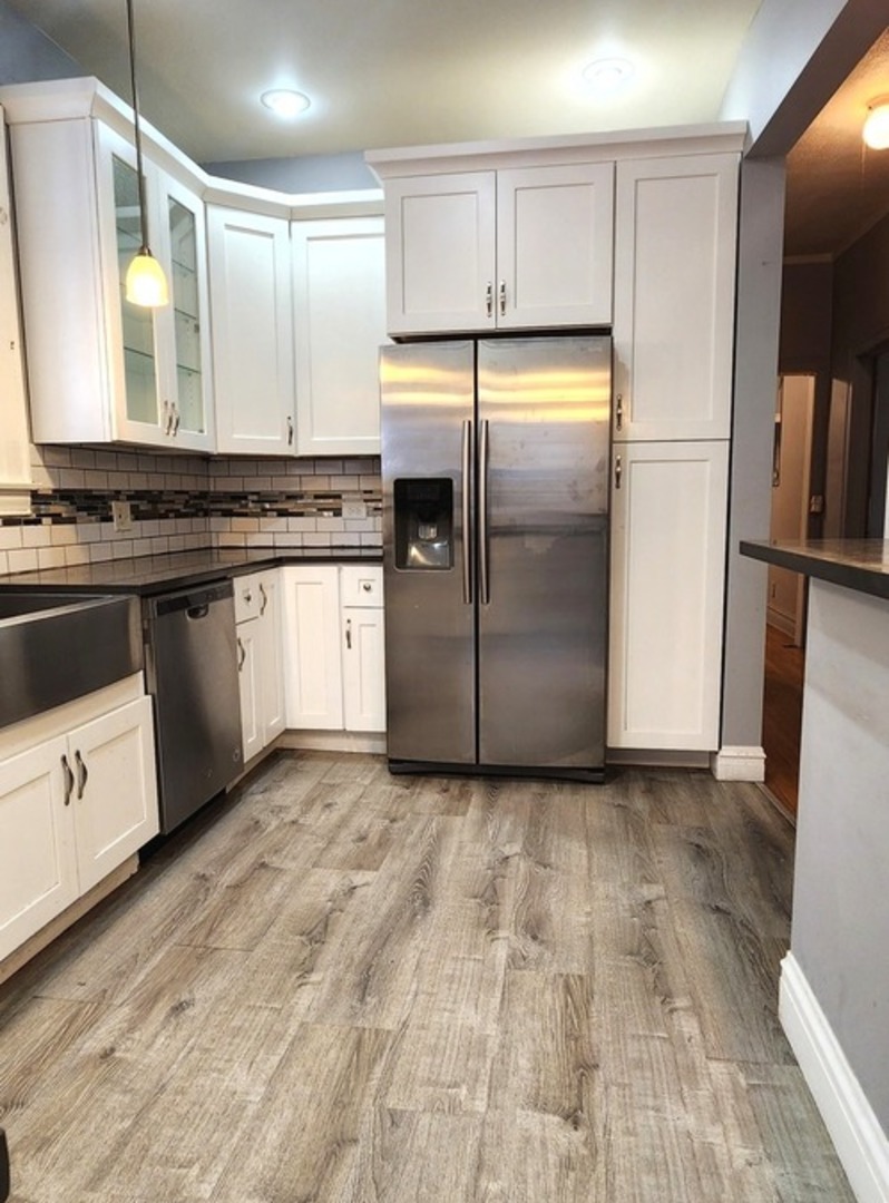 7227 South Bennett Avenue Chicago, IL 60649 - Photo 20 of 47 a kitchen with granite countertop a refrigerator and a sink