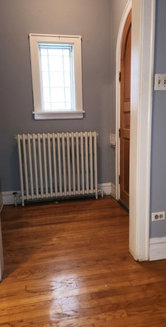 7227 South Bennett Avenue Chicago, IL 60649 - Photo 3 of 47 a view of a room with wooden floor and windows