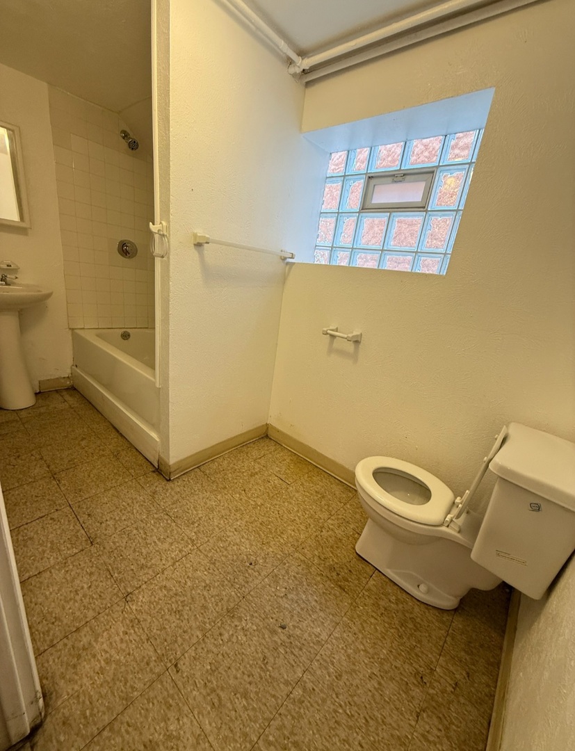 7227 South Bennett Avenue Chicago, IL 60649 - Photo 34 of 47 a bathroom with a granite countertop toilet and a shower