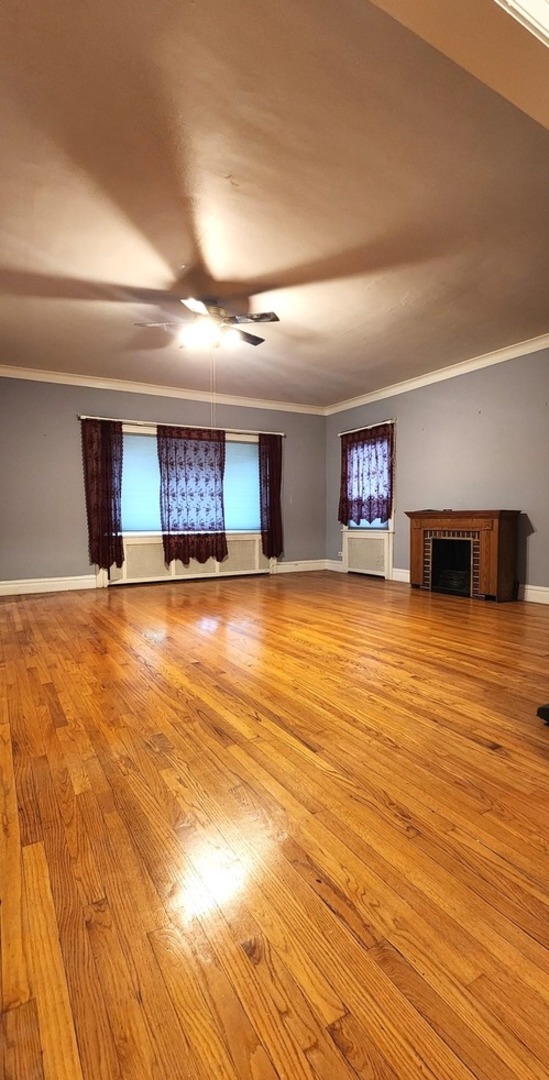 7227 South Bennett Avenue Chicago, IL 60649 - Photo 4 of 47 a view of a room with wooden floor