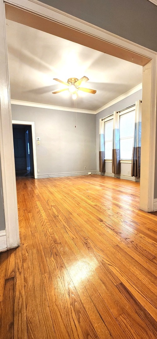 7227 South Bennett Avenue Chicago, IL 60649 - Photo 8 of 47 a view of a room with wooden floor and a window