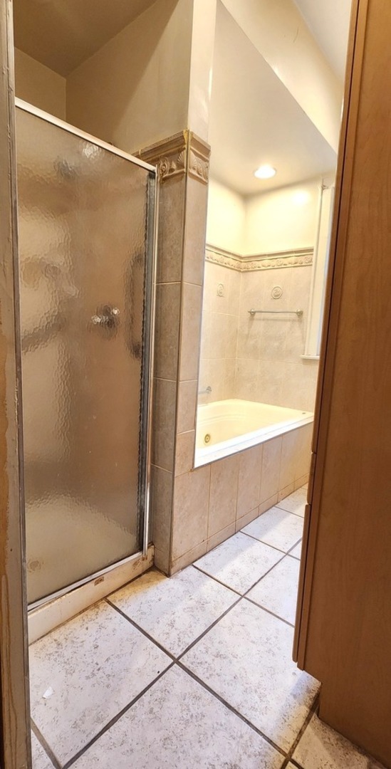 7227 South Bennett Avenue Chicago, IL 60649 - Photo 9 of 47 a bathroom with a glass shower door