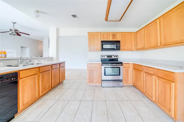 a kitchen with stainless steel appliances a stove sink and cabinets