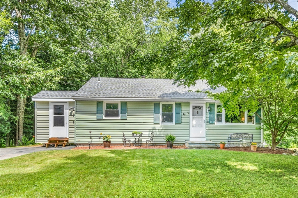 8 Birchwood Road Rutland, MA 01543 - Photo 1 of 40 a front view of a house with a yard and trees