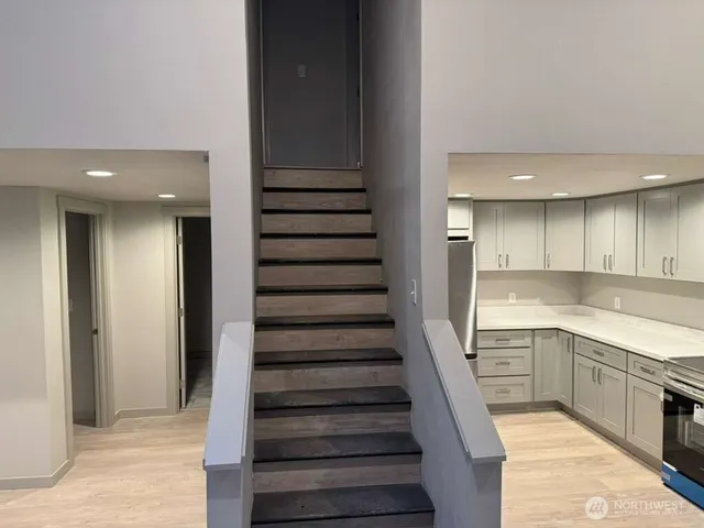a view of a kitchen with sink and cabinets