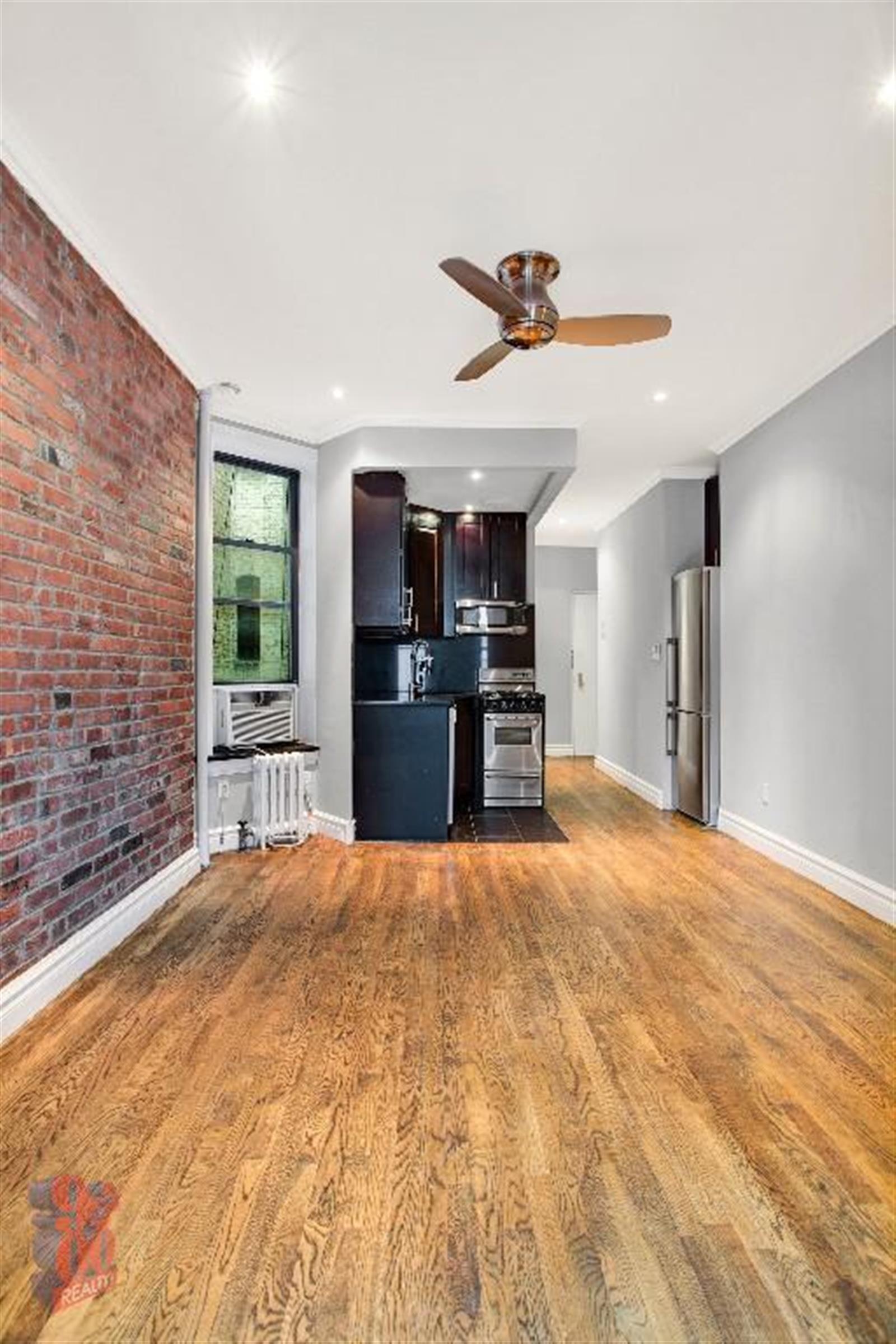 250 Mott Street, Unit 13 Manhattan, NY 10012 - Photo 3 of 5 a big room with closet and windows