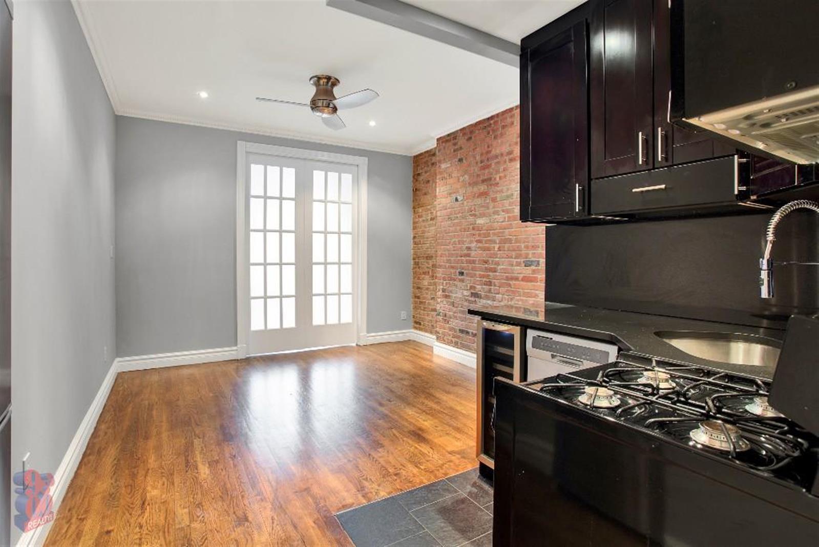 250 Mott Street, Unit 13 Manhattan, NY 10012 - Photo 5 of 5 a kitchen with wooden floors and a stove