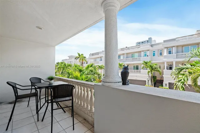 a view of balcony with two chairs and a potted plant