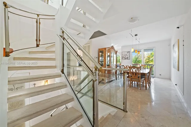 a view of entryway and hall with dining area