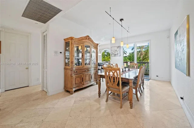 a dining room with furniture a chandelier and a rug
