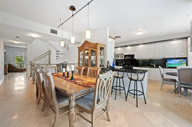 a dinning area with furniture and kitchen view