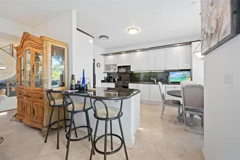 a kitchen with a table chairs stove and cabinets