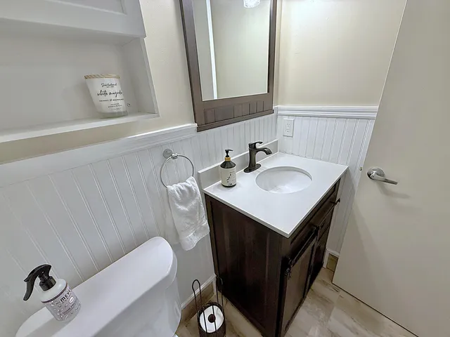a living room with furniture a wooden floor and next to a window