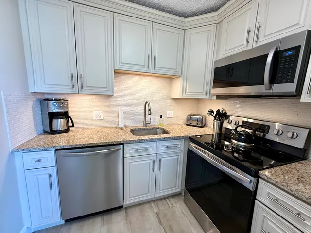 a view of a livingroom with furniture and a flat screen tv