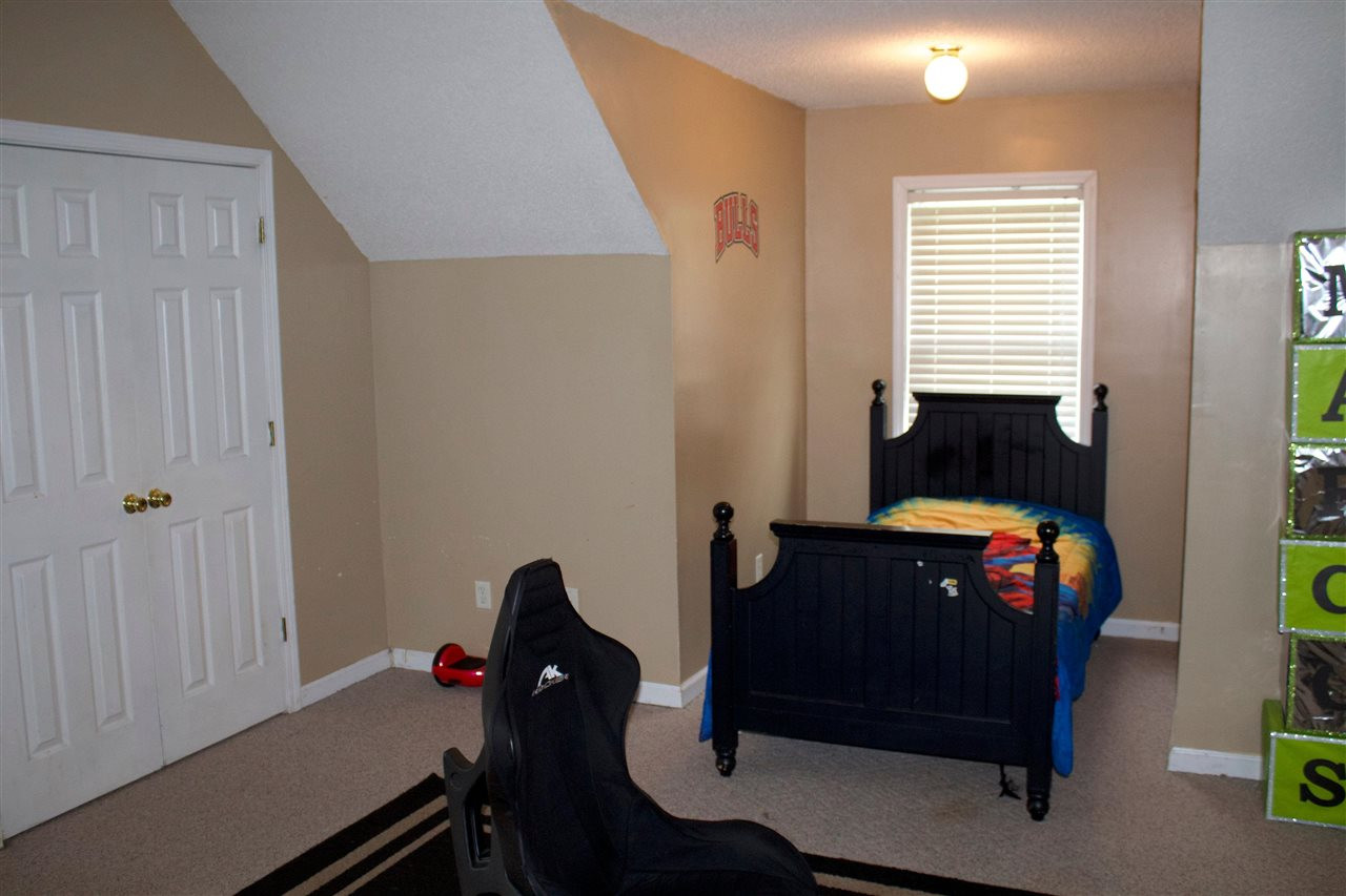 91 Collins Street Ripley, TN 38063 - Photo 13 of 18 a bedroom with a bed and a closet