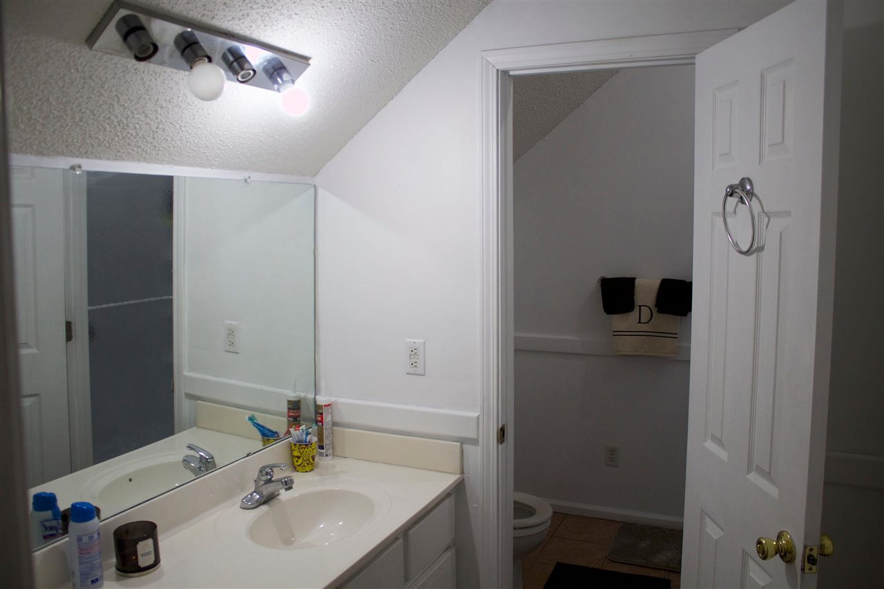 91 Collins Street Ripley, TN 38063 - Photo 14 of 18 a bathroom with a sink and a mirror