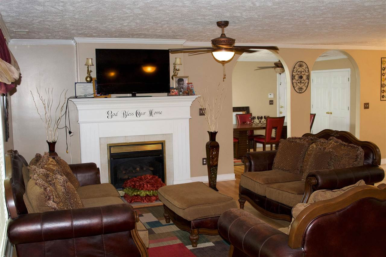 91 Collins Street Ripley, TN 38063 - Photo 3 of 18 a living room with furniture and a fireplace