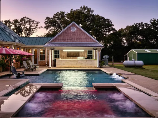 a view of a house with lounge chairs in patio