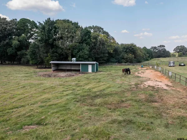 a view of a lake with a yard and trees