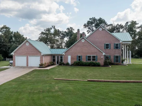 a large kitchen with stainless steel appliances granite countertop a stove top oven a sink and dishwasher