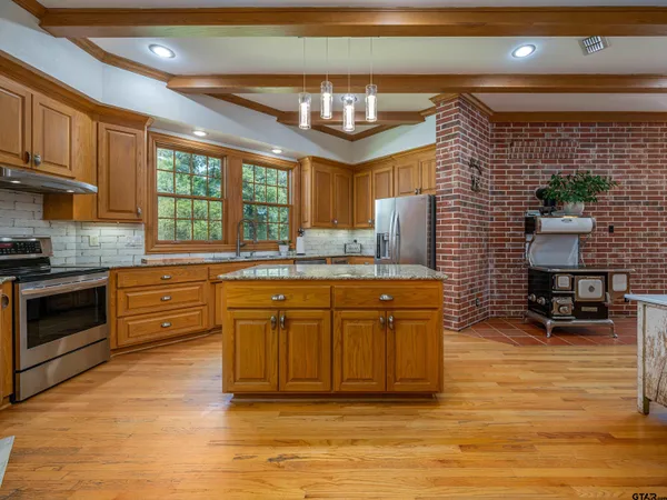 a dining room with furniture a chandelier and wooden floor