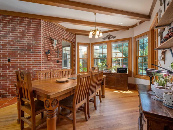 a kitchen with stainless steel appliances granite countertop a coffee maker a sink and white cabinets