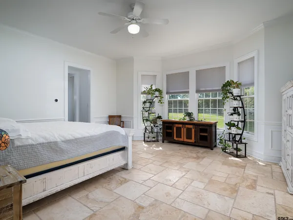a spacious bathroom with a granite countertop sink and a mirror