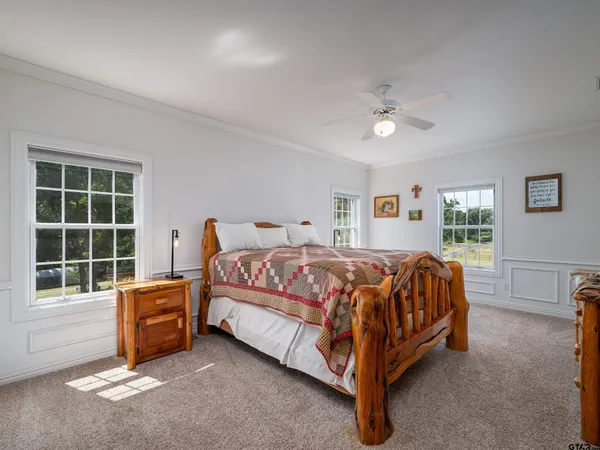 a spacious bedroom with a bed and a window