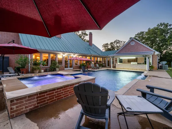 a view of a swimming pool with outdoor seating space