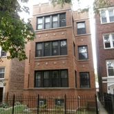 a front view of a house with a fence