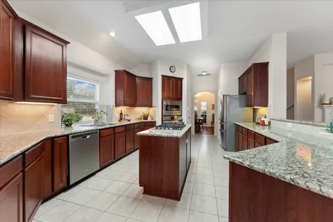 a kitchen with a stove sink and cabinets