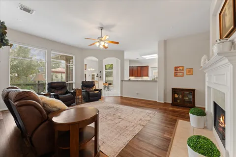 a living room with fireplace furniture and a floor to ceiling window