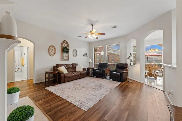 a living room with furniture a couch and a chandelier