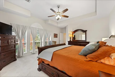 a bedroom with a bed and ceiling fan