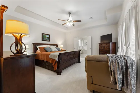 a bedroom with a bed and dresser with mirror