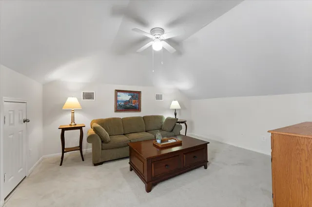a living room with furniture and a lamp