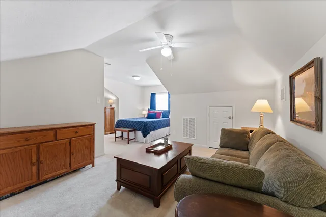 a living room with furniture a rug and a chandelier