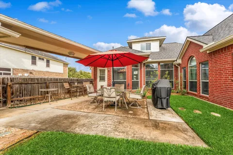 a view of a house with backyard porch and sitting area