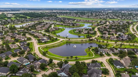 an aerial view of a residential houses with outdoor space and swimming pool