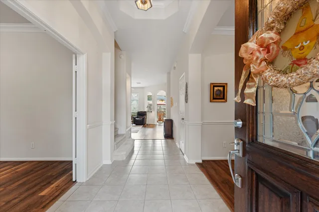 a view of a hallway with two couches and a fireplace