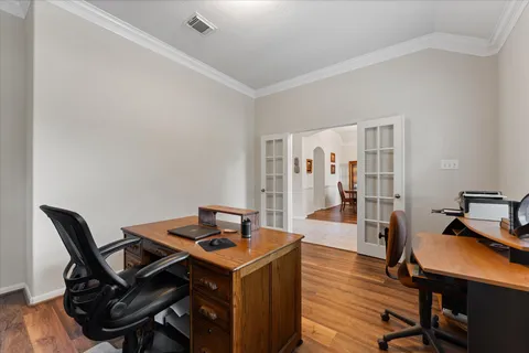 a view of a workspace with furniture and wooden floor