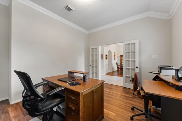 a view of a workspace with furniture and wooden floor
