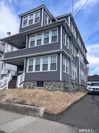a front view of a residential apartment building with a yard