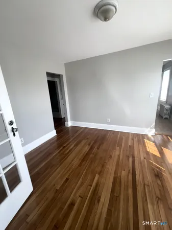a view of wooden floor in an empty room